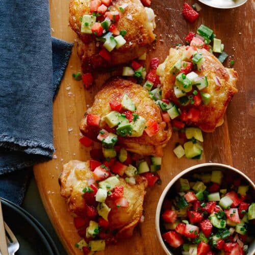 Roasted chicken thighs with strawberry avocado salsa on top and on the side.