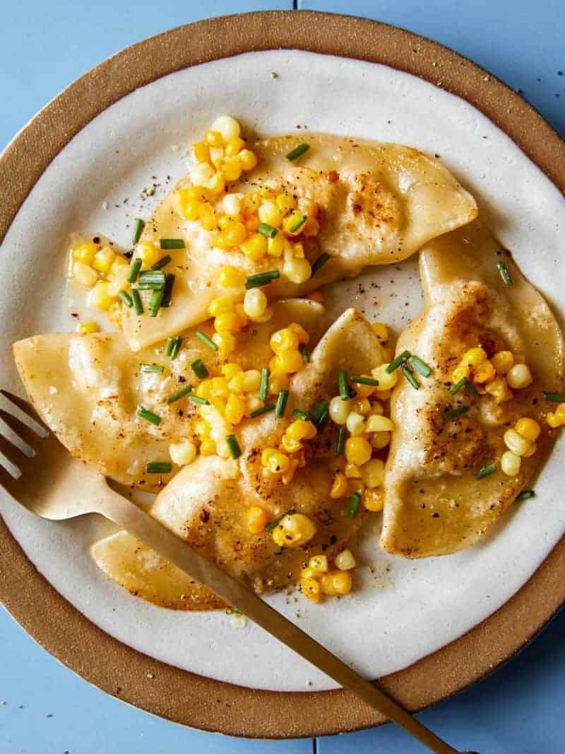 Creamy shrimp and corn ravioli on a plate with a fork.