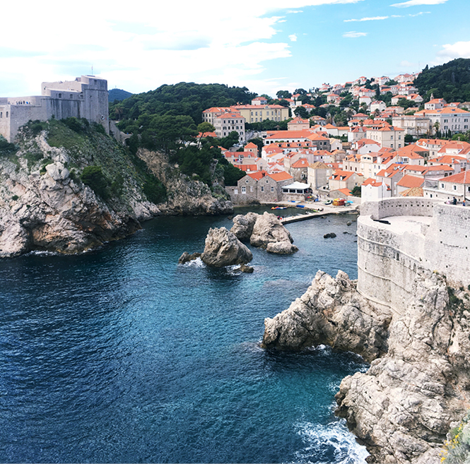 A body of water with Dubrovnik in the background.