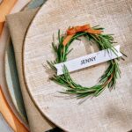 Rosemary wreath place card up close on a plate.