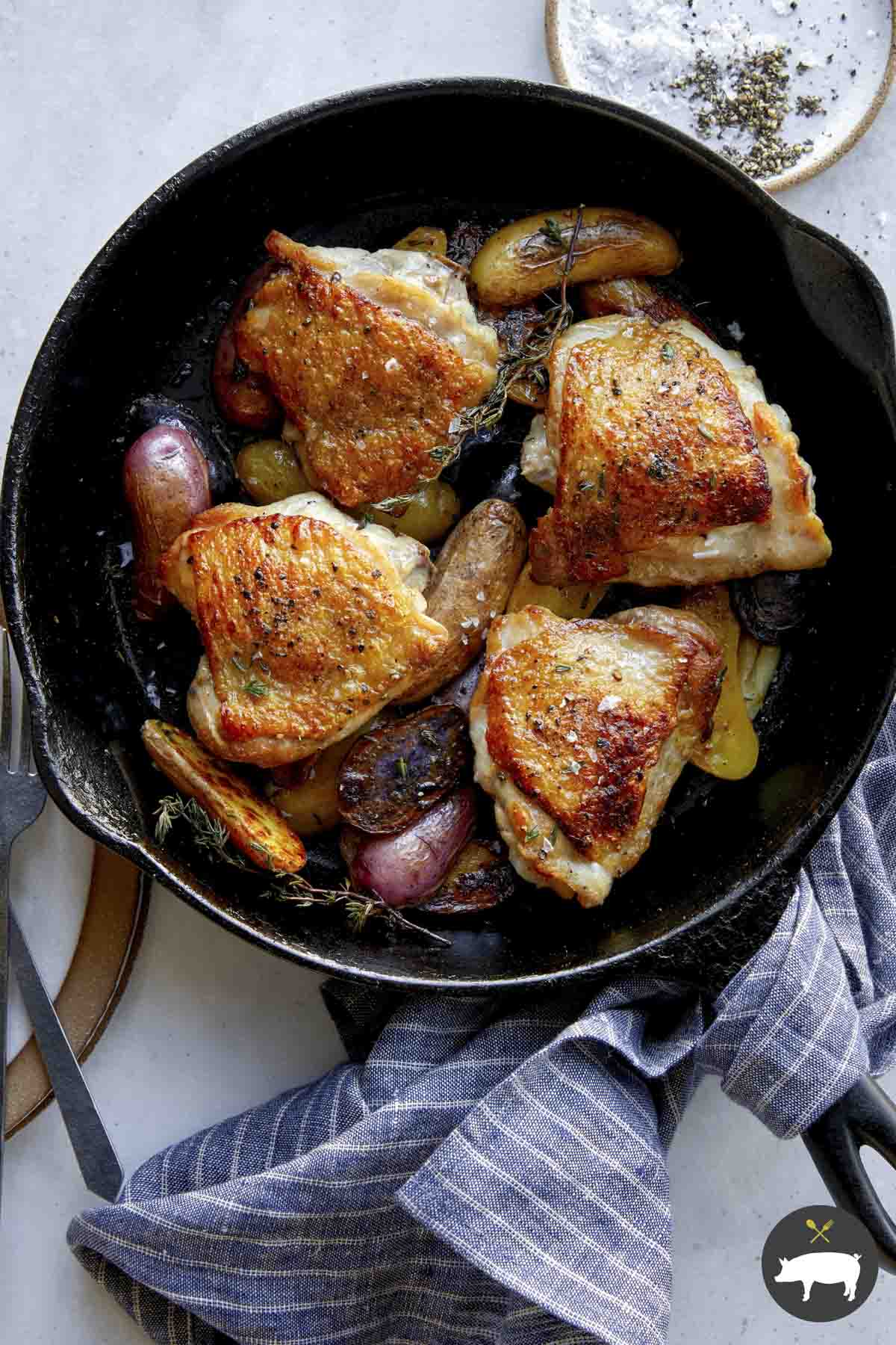 Crispy chicken thigh recipe in a skillet.