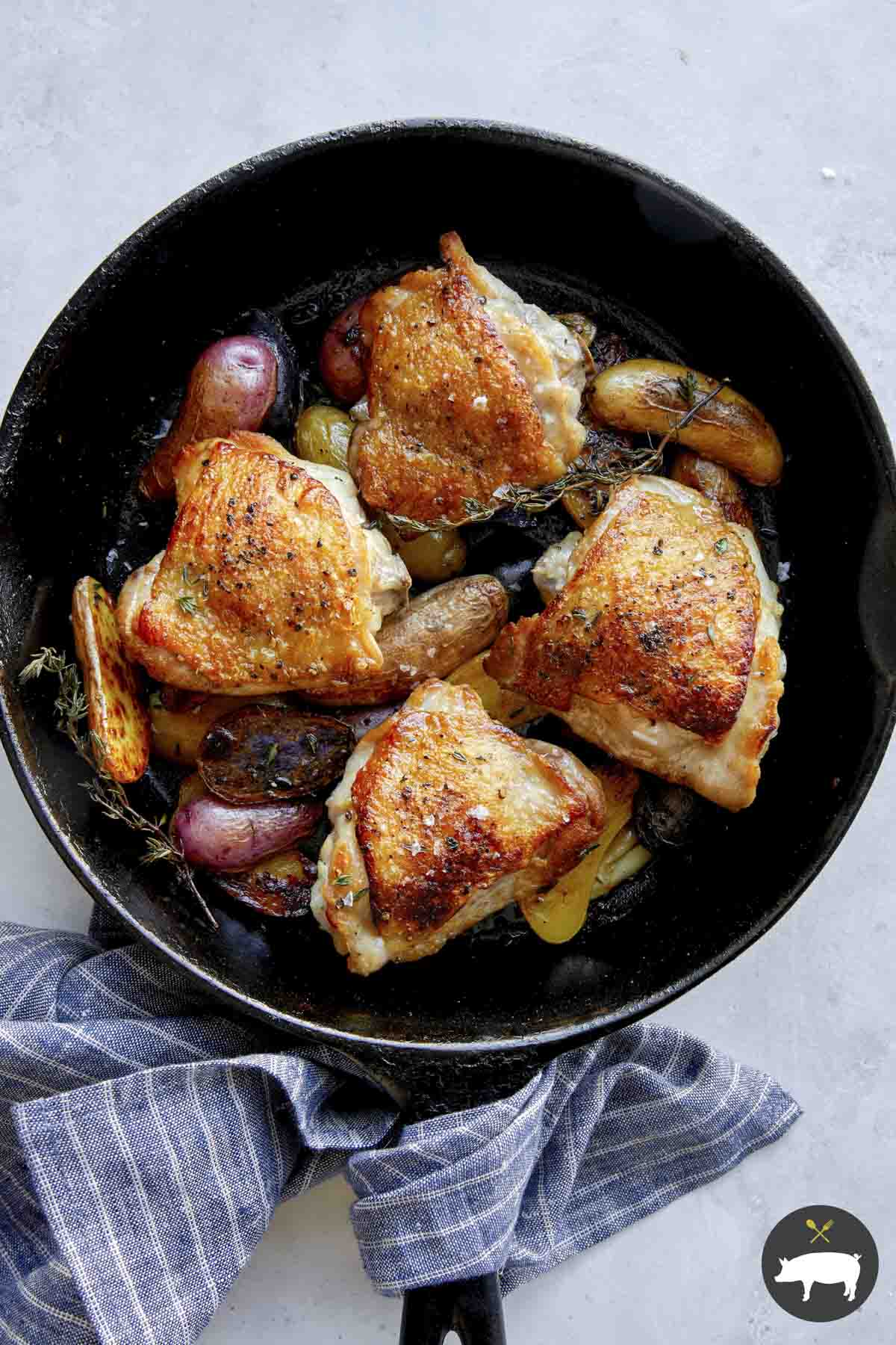 Crispy chicken thigh recipe in a skillet.