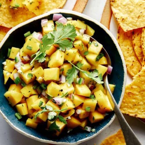 Mango salsa in a bowl with chips.