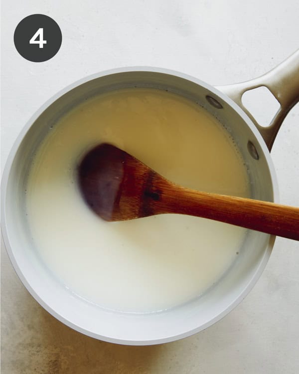 Making pudding a stock pot with a wooden spoon. 