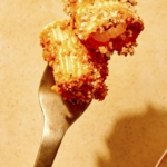 Romesco sauce pasta speared on a fork.