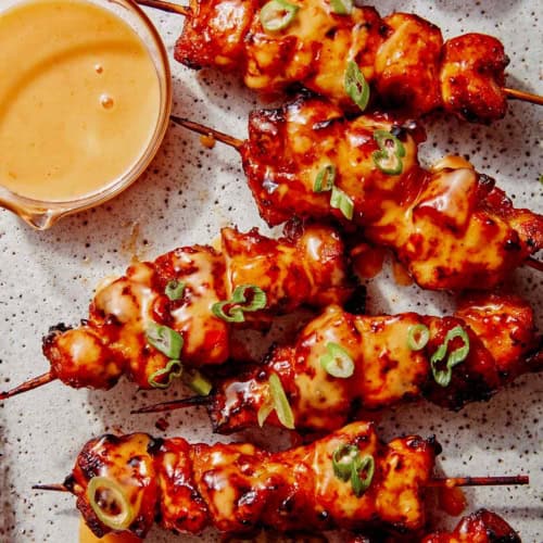 Air fryer bang bang chicken skewers on a platter.