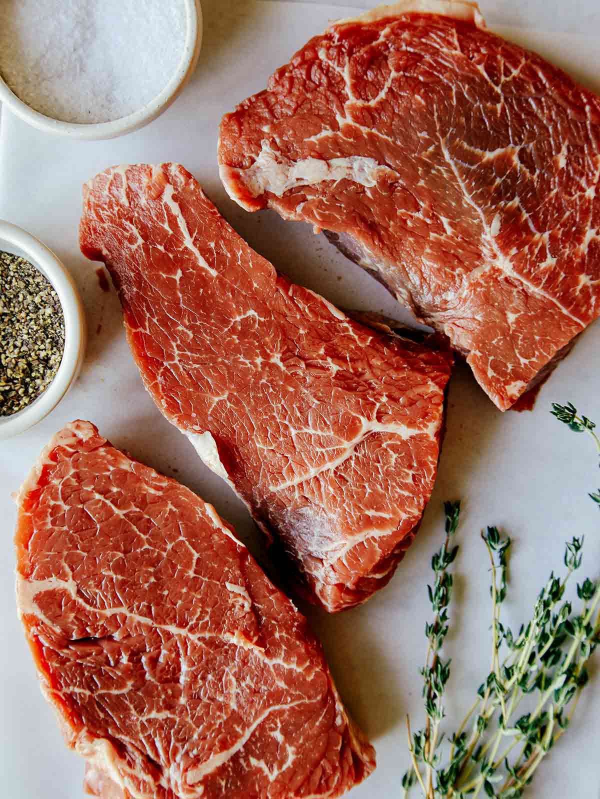 Three pieces of sirloin steak. 