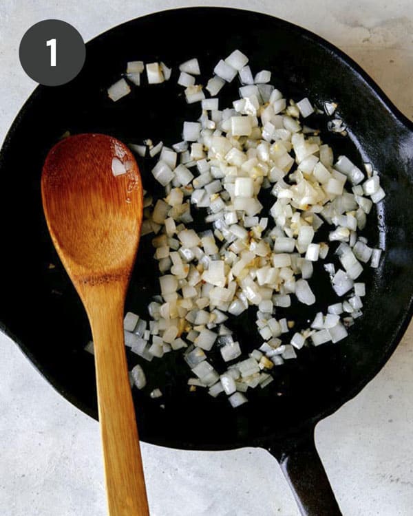 Sautéd onion and garlic in a skillet, the first step to make chilaquiles. 