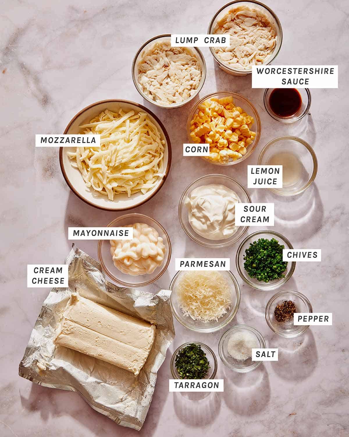 Ingredients to make a hot crab dip on a kitchen counter. 