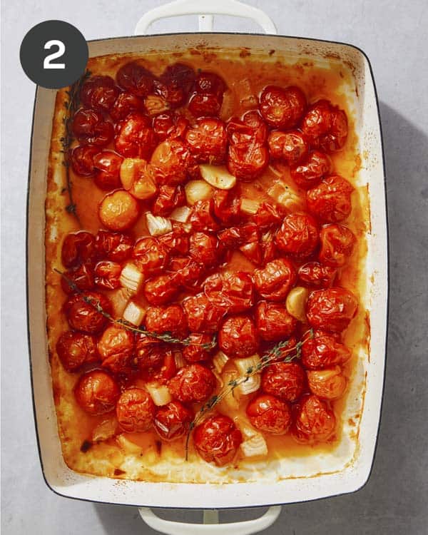 Cherry tomatoes roasted in a baking dish.