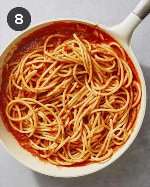 Fresh tomato sauce recipe being tossed with pasta.