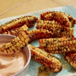 Air Fryer corn ribs on a platter with a dipping sauce.