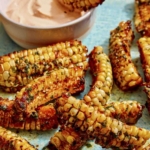 Air Fryer corn ribs on a platter with a dipping sauce.