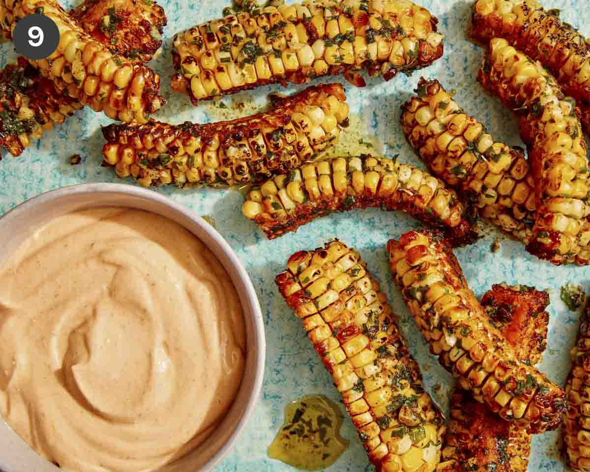 Corn ribs on a platter with a dipping sauce.