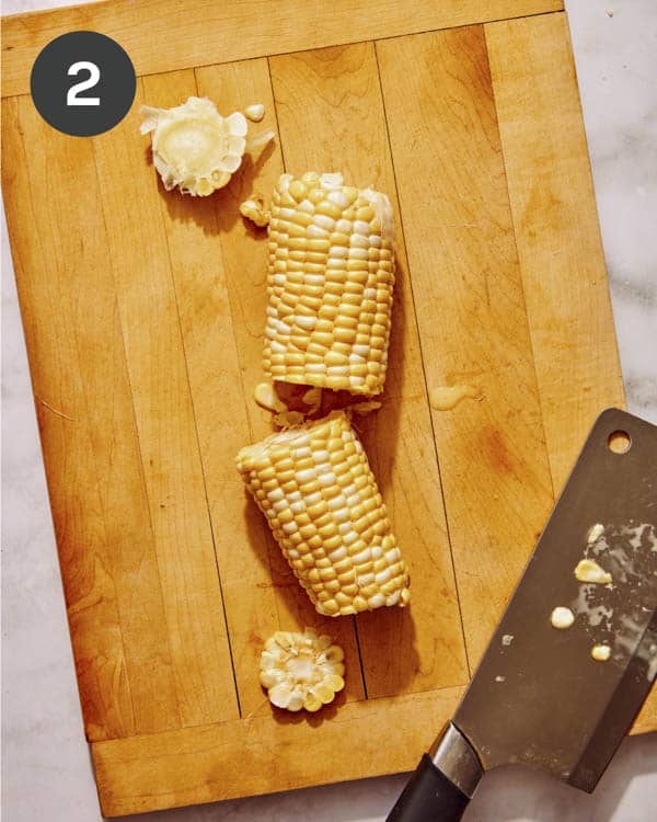 A cob of corn with the ends cut off then cut in half.