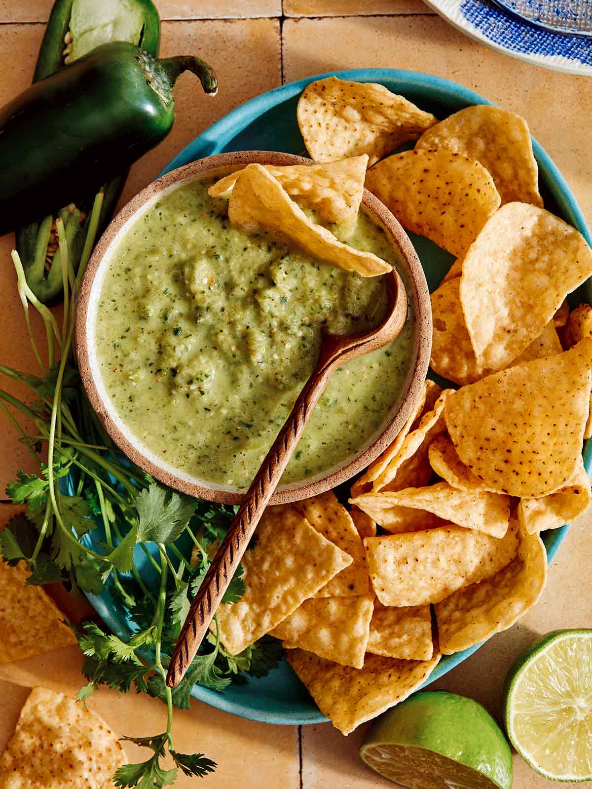 Tomatillo salsa in a bowl with a spoon in it being served.