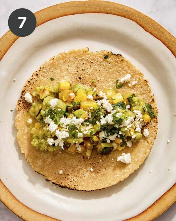 A vegetarian taco on a plate with toppings.