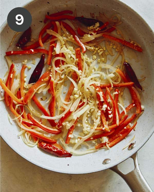 Peppers with ginger and garlic cooking in a skillet. 