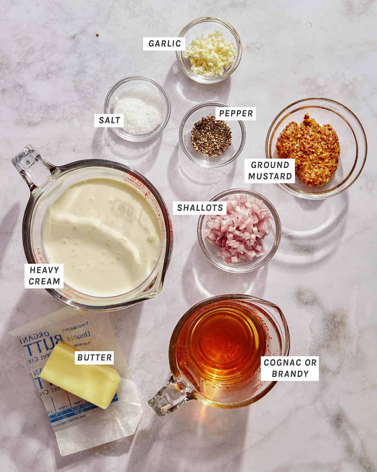 Ingredients for a mustard cream sauce to top pork chops.