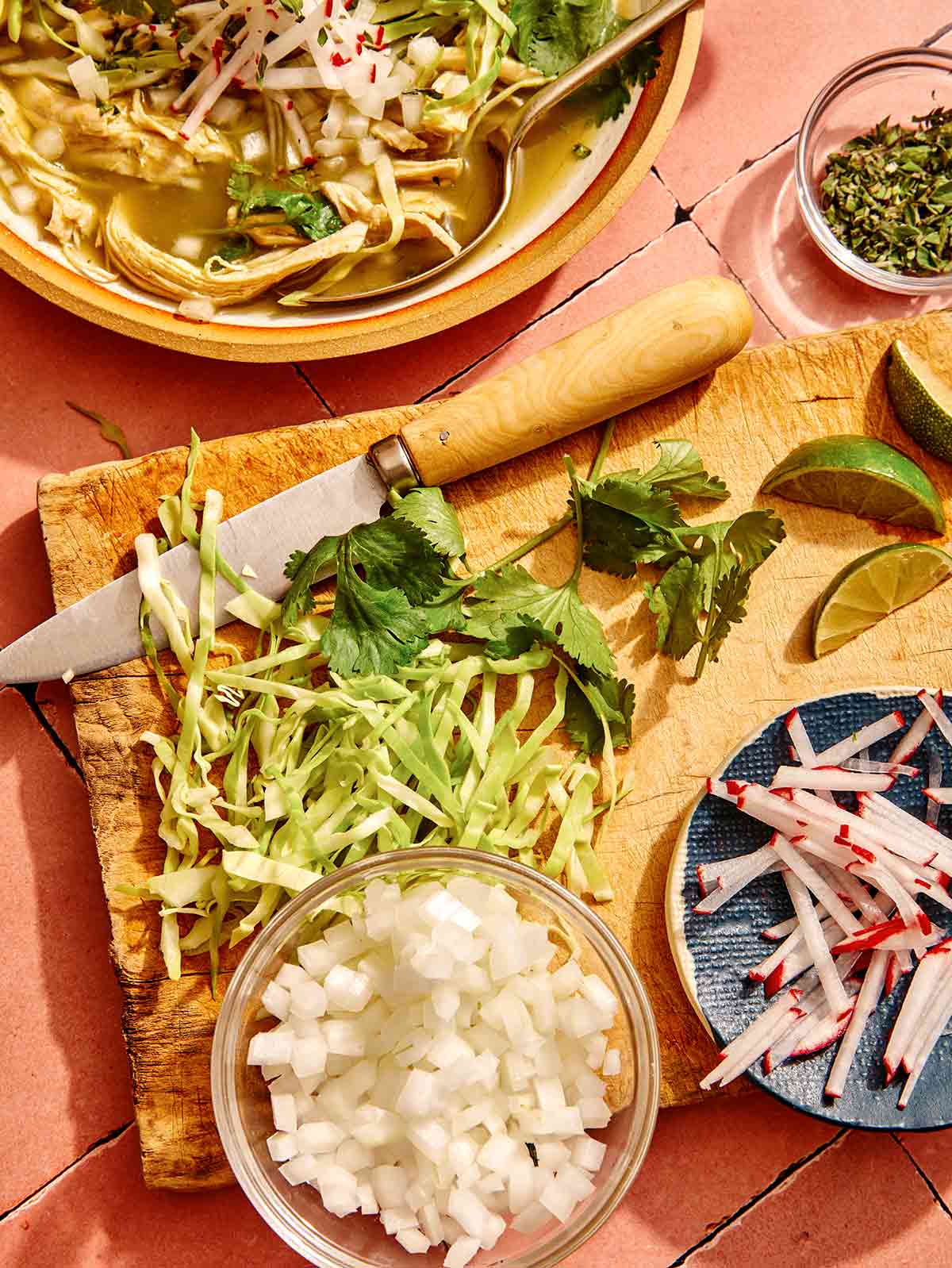 Garnishes for chicken pozole verde on a cutting board.