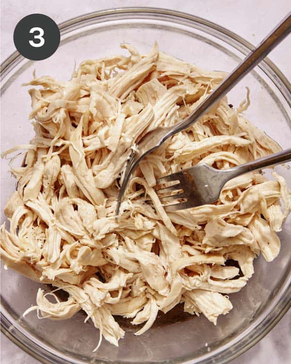 Shredded chicken breast in a bowl.