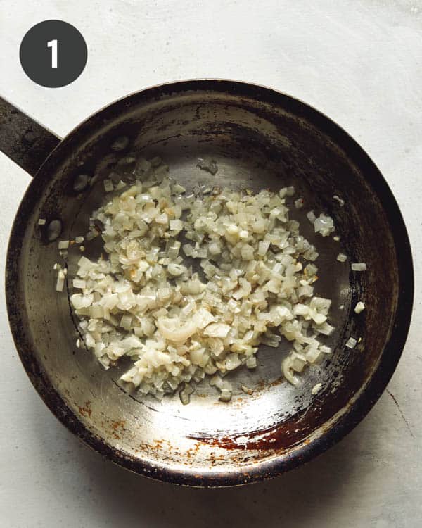 Sauté shallots and garlic in a skillet. 