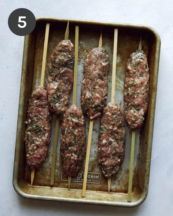 Ground lamb formed onto skewers to be grilled to make Lamb Kofta.