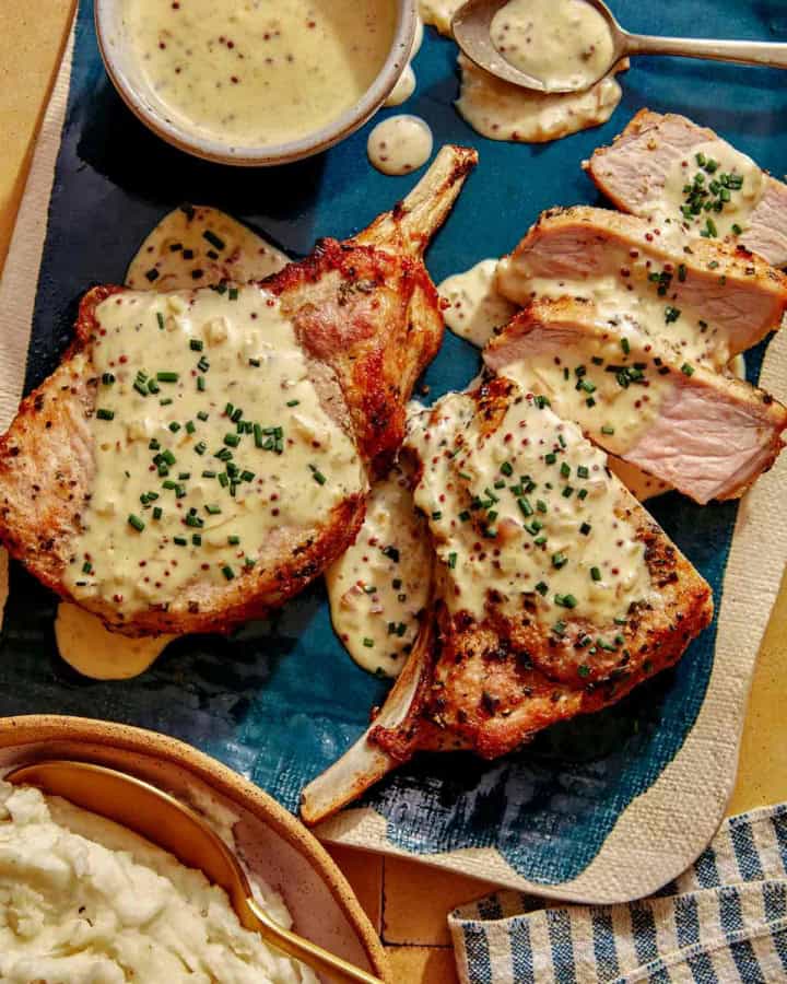 Air fryer pork chop recipe on a platter with a cream sauce.