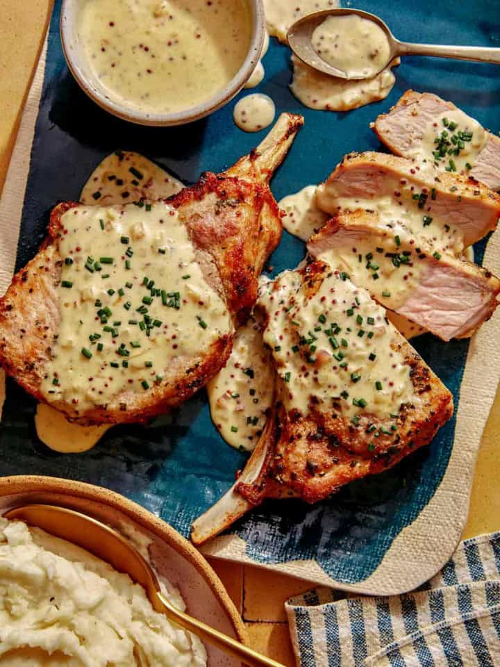 Air fryer pork chop recipe on a platter with a cream sauce.