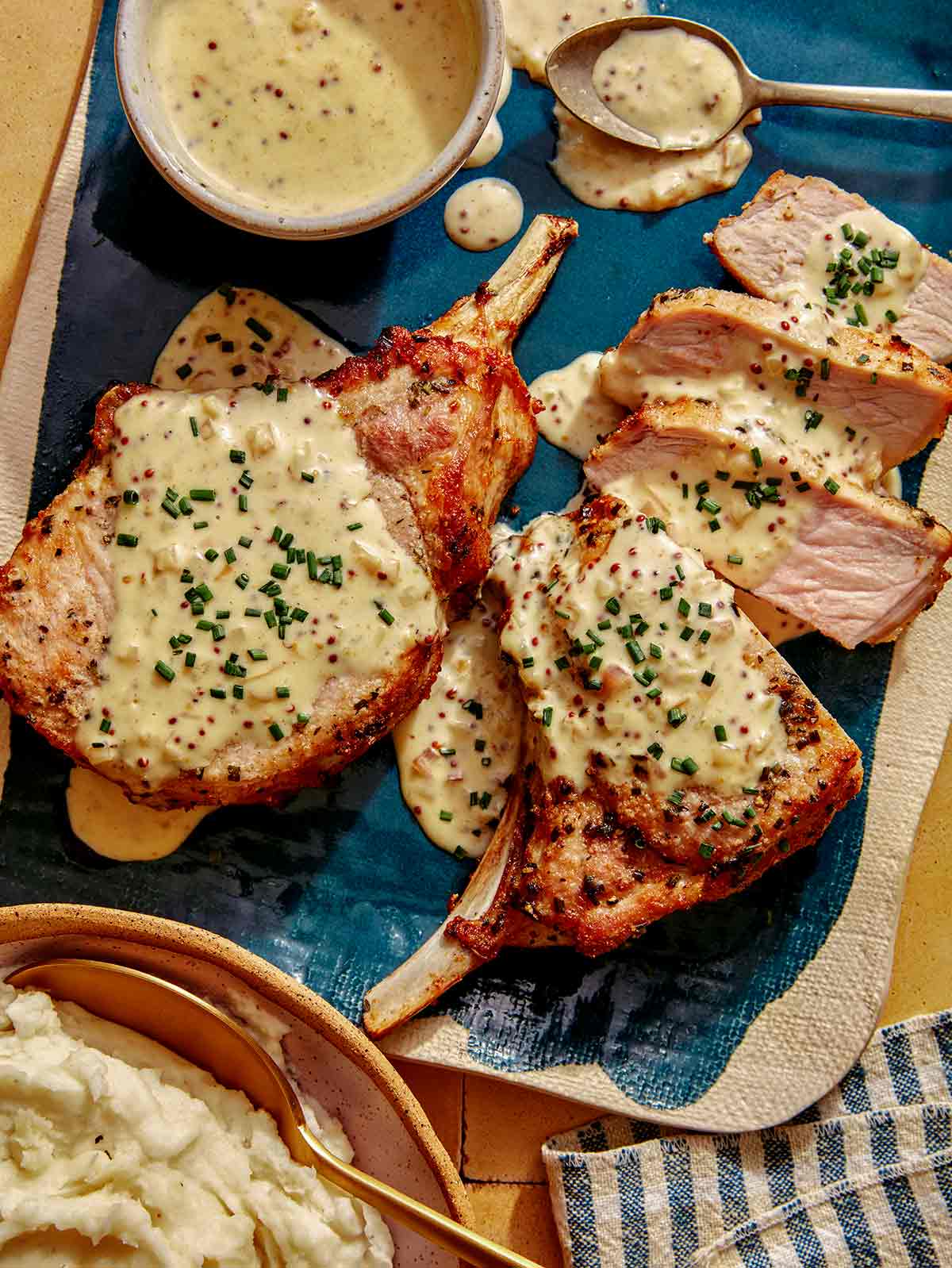 Air fryer pork chop recipe on a platter with a cream sauce. 