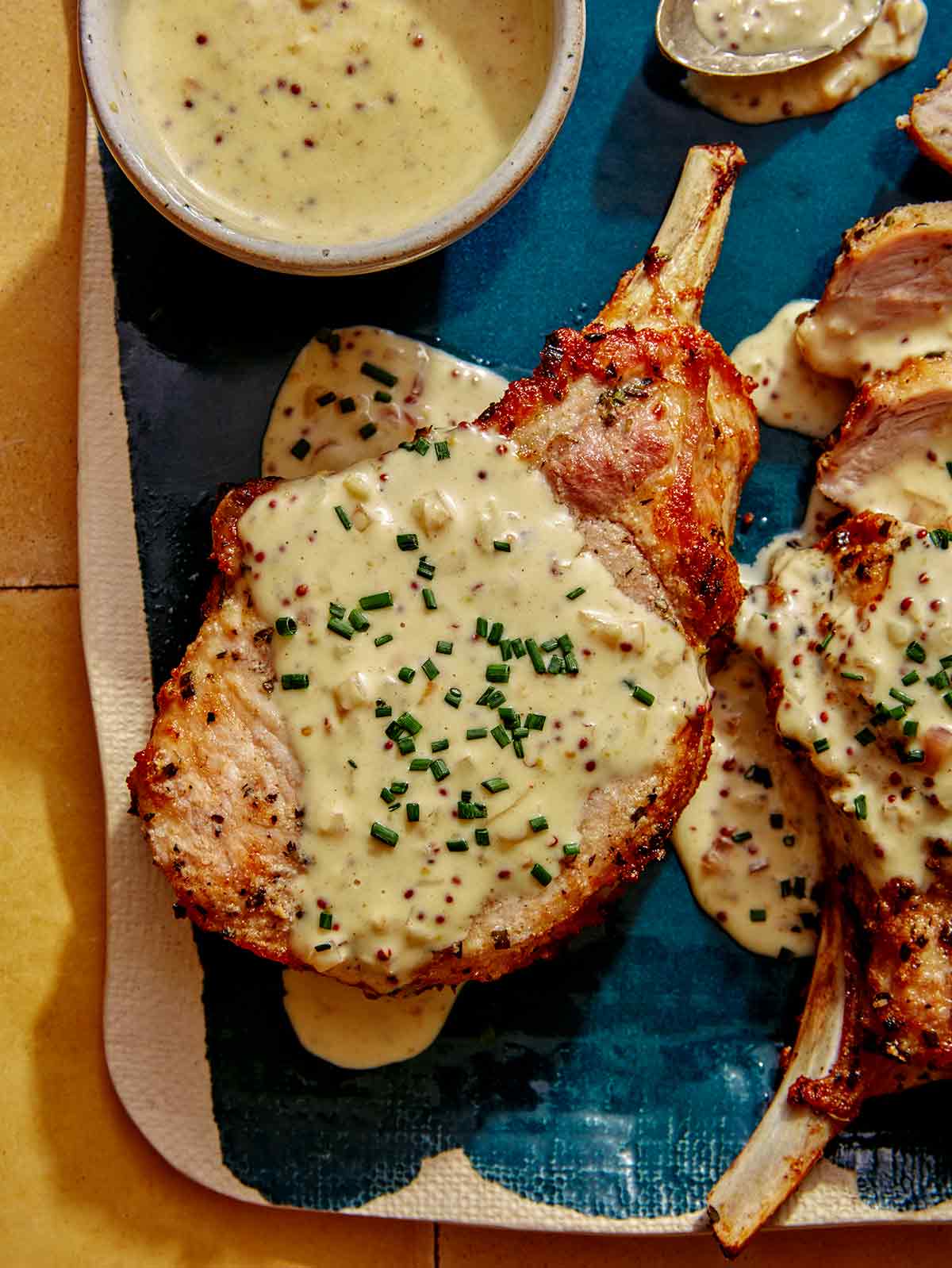 A whole air fryer pork chop on a platter.