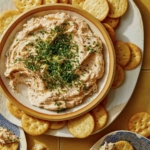 Smoked Salmon Dip recipe in a bowl with crackers on the side.